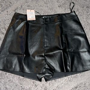 Black faux leather shorts.